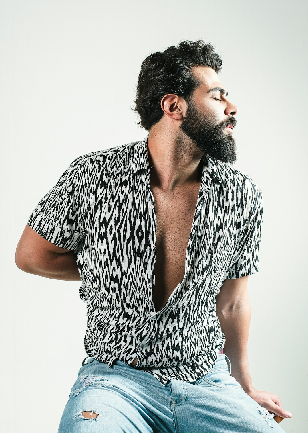 Studio portrait of a Hispanic man in his 60s with a beard, historian