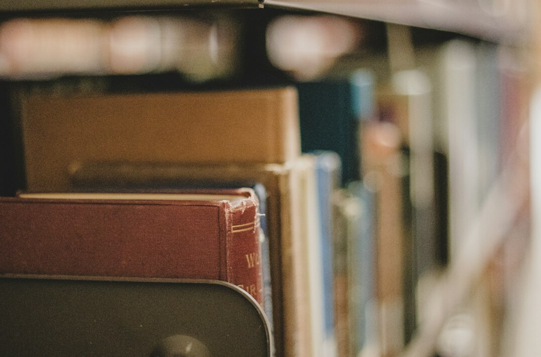 Stack of old hardcover books in a library