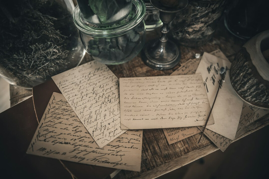 Old sepia-toned historical documents and envelopes on a table