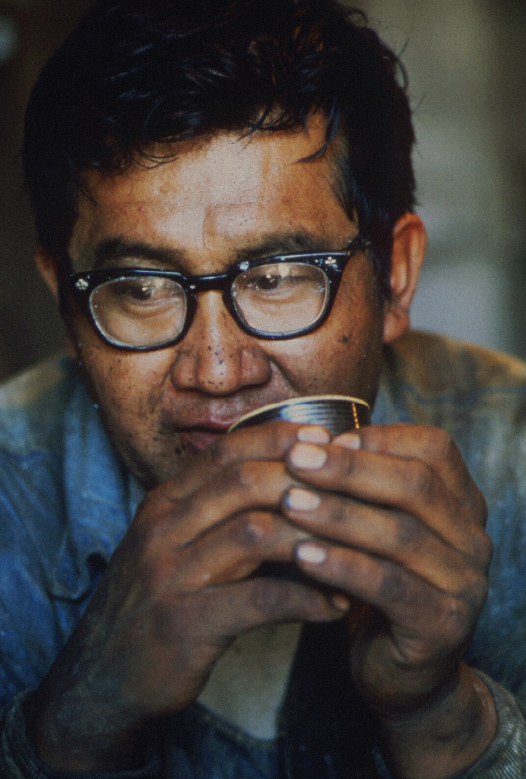 Studio portrait of a Hispanic man in his 50s with glasses, senior writer